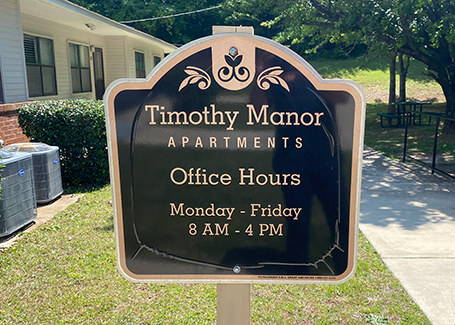 Sign for Timothy Manor apartments.